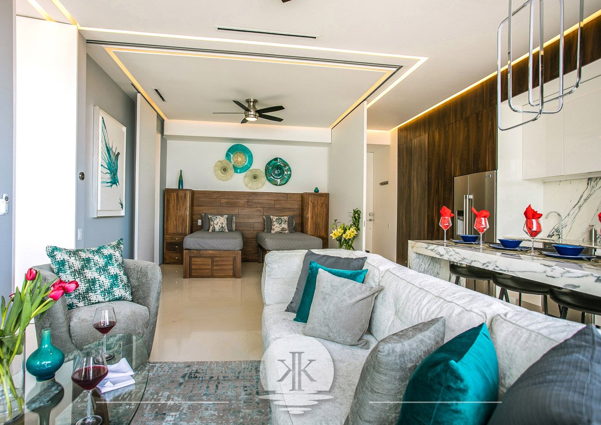 The living room with a view of the guest bedroom with the retractable walls open